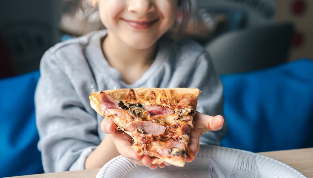 an-appetizing-piece-of-pizza-in-the-hands-of-little-girl